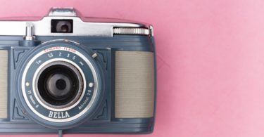 gray and silver camera on pink surface