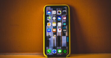turned on iphone x with yellow case