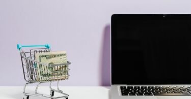 shopping cart next to a laptop