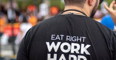 person wearing eat right work hard feel good printed shirt