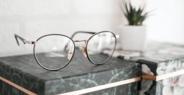 gray framed eyeglasses on black surface