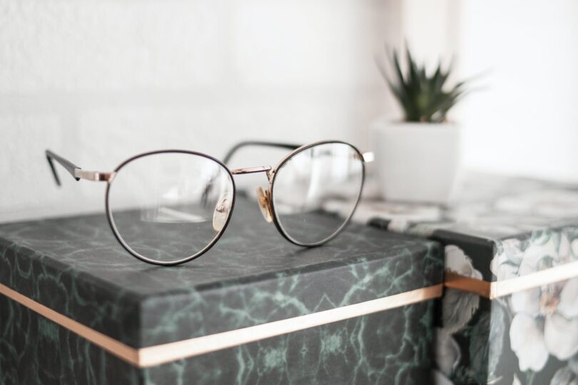 gray framed eyeglasses on black surface
