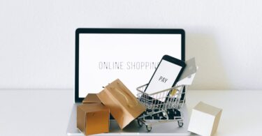 a miniature shopping cart on macbook laptop