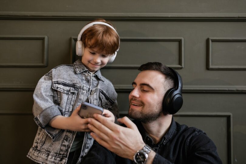 father and son listening to music