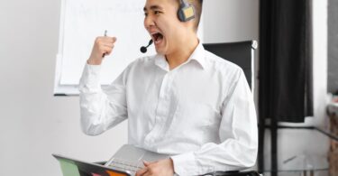 man in white dress shirt wearing headphones