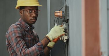 an electrician repairing a fuse box