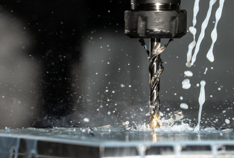 close up phot of a cnc milling machine with metalworking fluid