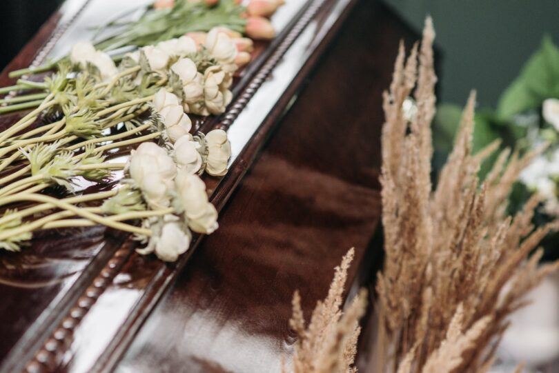 white flowers on the coffin