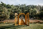 wedding arch and guest benches placed in verdant park