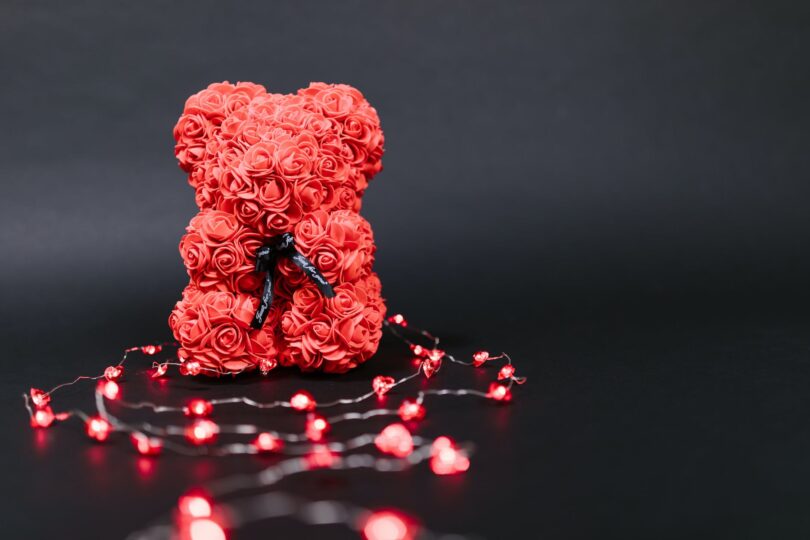 red teddy bear shaped valentine s gift on black background