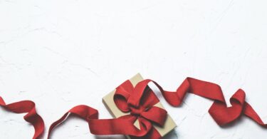 red and white gift box with ribbon bow