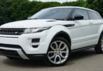 white land rover range rover suv on road