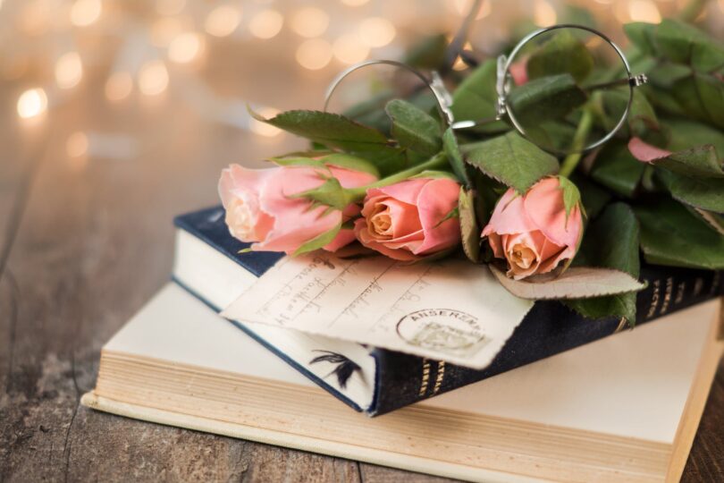 pink rose flowers and book