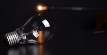 clear filament bulb on black pad