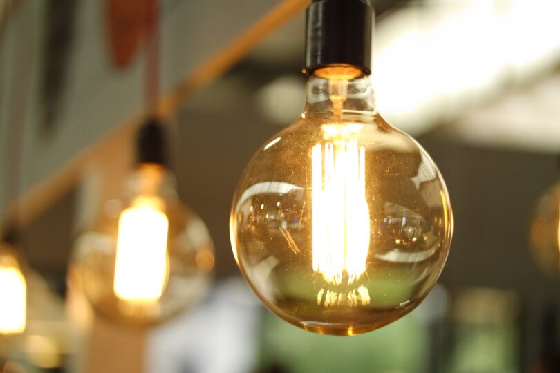 lighted light bulb in selective focus photography