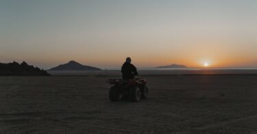 person riding a quad bike in the desert