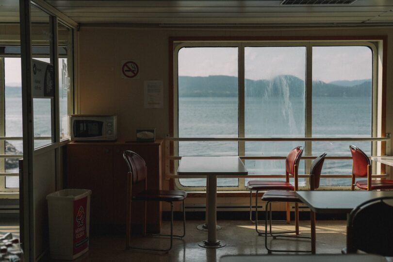 an empty table with chairs in the ship