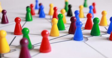 close up photography of yellow green red and brown plastic cones on white lined surface