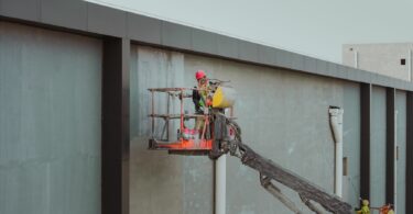 construction workers on crane at building site in huaian
